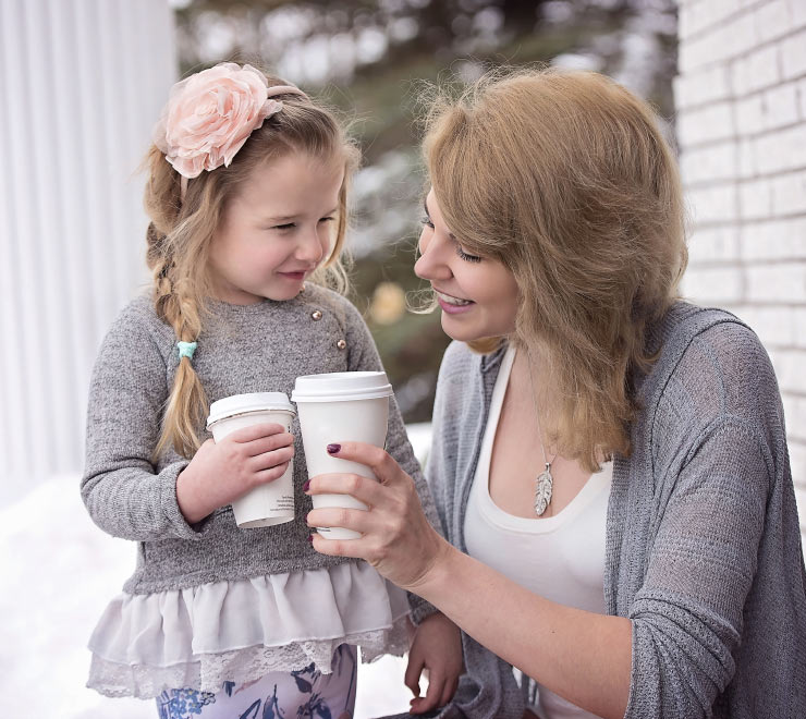 Mother and Daughter Holding Takeout Cups